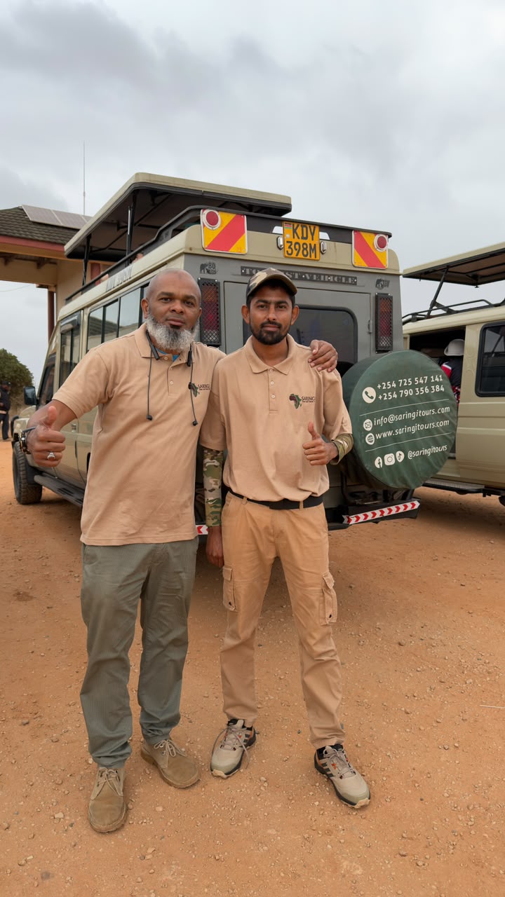 Saringi Tours guides in uniform beside a safari vehicle, Mombasa